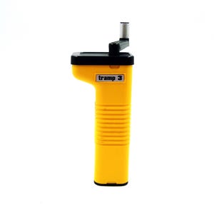 May include: A yellow hand-cranked device with the text "tramp 3" on the side. The device has a black top and a silver-colored crank handle. The body is ribbed and cylindrical.