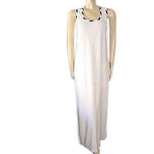 May include: A sleeveless, floor-length white dress. The dress has a scoop neckline with black trim. The fabric appears to be lightweight and flowing. The dress is displayed on a mannequin.