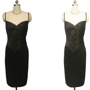 May include: A black sleeveless dress with a pleated bodice and a fitted skirt.