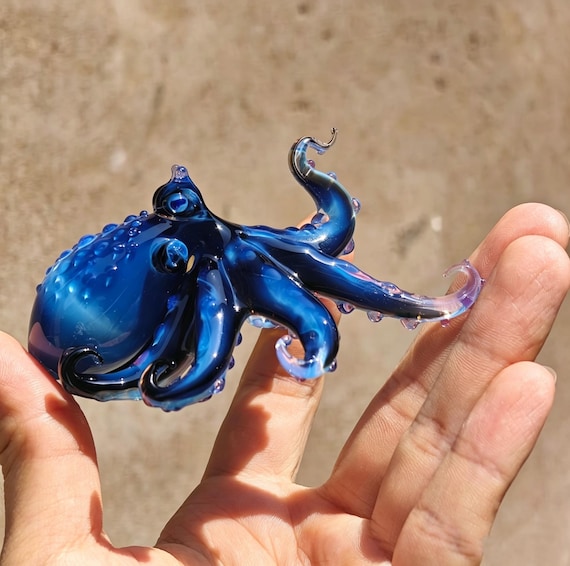 A hand-blown glass octopus sculpture with the kind of iridescent, tentacle-swirling detail that stops people dead in their tracks — this is a statement piece, not a trinket.