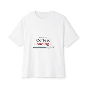 May include: A white short-sleeved t-shirt featuring black and red text that reads MORNING.EXE Coffee: Loading... with a progress bar at 60% and the additional text // please wait. human offline. printed in the center of the chest area.