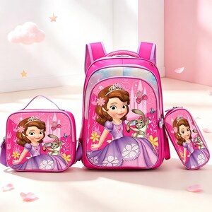 May include: A bright pink school set consisting of a backpack, a lunch bag, and a pencil case. Each item features a graphic print of a cartoon princess with brown hair wearing a purple dress and a tiara, accompanied by a small gray rabbit character.