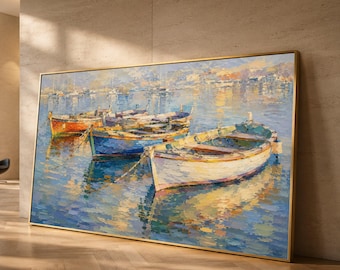 May include: A rectangular oil painting in a gold frame depicting three small wooden boats floating on calm blue water. The scene features a white boat in the foreground, a blue boat in the middle, and an orange boat behind, with reflections of the vessels and distant harbor structures visible on the water surface.