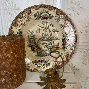 May include: A white ceramic mug with a black handle and the text "But First, Coffee" in a black, bold font. The mug is sitting on a wooden surface. The mug is approximately 4 inches tall.