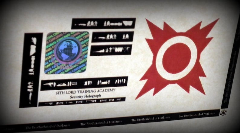 May include: A close-up of a security hologram with a red starburst design and the text "SITH LORD TRAINING ACADEMY Security Holograph". The hologram has a holographic globe in the upper left corner.