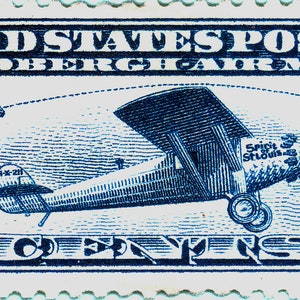 May include: A blue and white United States postage stamp featuring a blue airplane with the text "Lindbergh Air Mail" and "10 Cents". The stamp depicts the flight path of Charles Lindbergh's historic transatlantic flight from New York to Paris.