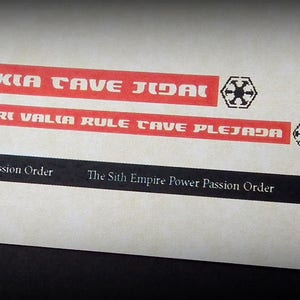 May include: A black and white image of a Star Wars themed sticker sheet. The sheet has a red and white stripe with the text "MIRTIS KIA CAVE JIDAL" and "CAVE TSIS ARI VALIA RULE CAVE PLEJADA". The sheet also has a black and white symbol of a star with a circle around it.