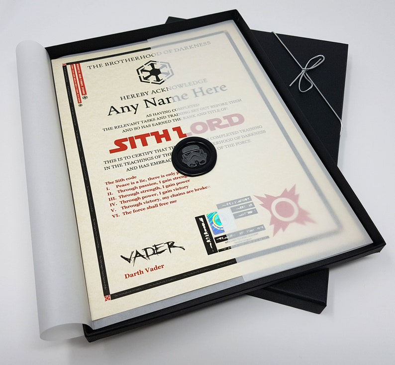 May include: A framed certificate with a black wax seal and a Star Wars theme. The certificate reads "The Brotherhood of Darkness hereby acknowledges [Name Here] as having completed the relevant tasks and training set out before them and so has earned the rank and title of Sith Lord." The certificate also includes the Sith code: "Peace is a lie, there is only strength. Through passion, I gain strength. Through strength, I gain power. Through power, I gain victory. Through victory, my chains are broken. The force shall free me."