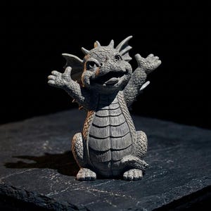 May include: A gray, textured dragon figurine with a cracked stone-like finish. The creature is depicted in a seated position with both arms raised upward, featuring detailed scales, small horns on its head, and a wide, open-mouthed expression.