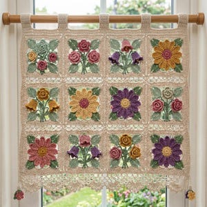 May include: A beige crochet window curtain featuring a grid of twelve square panels, each displaying three-dimensional floral motifs in shades of pink, yellow, purple, and green. The curtain hangs from a wooden rod with top loops and a scalloped edge.