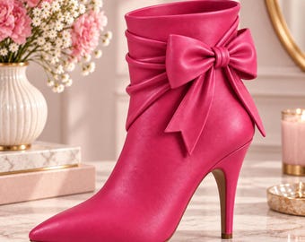 May include: A vibrant hot pink ankle boot featuring a pointed toe, a slim stiletto heel, and a large, decorative bow detail on the outer side. The boot has a smooth, matte finish and a gathered, ruched texture around the upper ankle area.