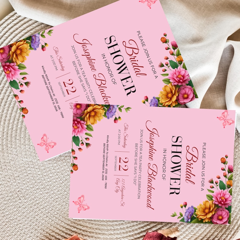 Luxury bridal shower invitation styled on textured fabric with vibrant garden inspired artwork and sophisticated keepsake presentation