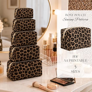 May include: A stack of five rectangular boxy pouches featuring a black and tan floral pattern with white zippers. The text on the image reads: BOXY POUCH Sewing Pattern, PDF, A4 PRINTABLE, 5 SIZES. The pouches are shown in five different sizes.