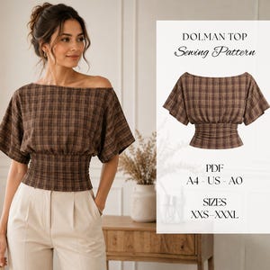 May include: A brown plaid dolman top sewing pattern featuring a wide neckline, short sleeves, and a shirred waist. The text reads: DOLMAN TOP Sewing Pattern, PDF, A4 - US - A0, SIZES XXS-XXXL. The garment is shown on a model and as a flat illustration.