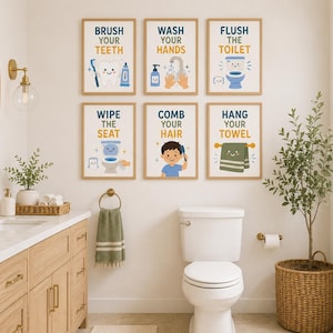 May include: A set of six rectangular wall art prints with light wood frames, each featuring a cartoon illustration and text: Brush Your Teeth, Wash Your Hands, Flush The Toilet, Wipe The Seat, Comb Your Hair, and Hang Your Towel in blue and yellow.