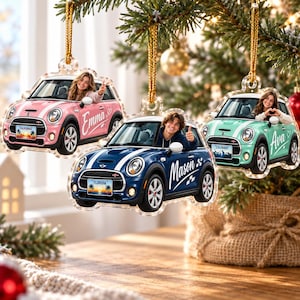 May include: Three custom acrylic car ornaments hanging from a tree. One pink car with the name Emma, one blue car with the name Mason, and one mint green car with the name Ava. Each car features a photo of a person in the driver seat and a license plate.
