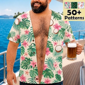 May include: A short-sleeved button-down shirt featuring a cream background with a repeating tropical pattern of pink hibiscus flowers, green palm leaves, and brown coconut halves. The shirt has a V-neckline and a front button closure.