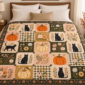 May include: A patchwork quilt featuring a repeating grid of square panels. The design includes illustrations of black cats, orange pumpkins, white polka-dot pumpkins, green and white gingham patterns, and various floral arrangements in shades of orange, pink, and white.
