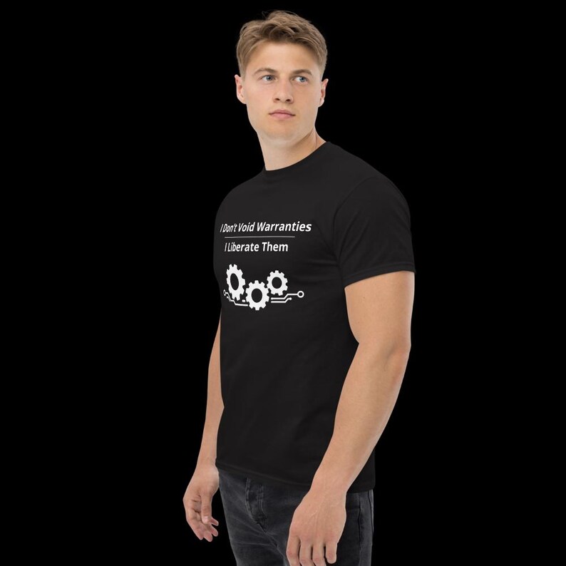 May include: A black short-sleeved t-shirt featuring white text that reads I Don't Void Warranties I Liberate Them above a graphic of three interconnected gears with circuit board lines extending from the sides of the gear design.