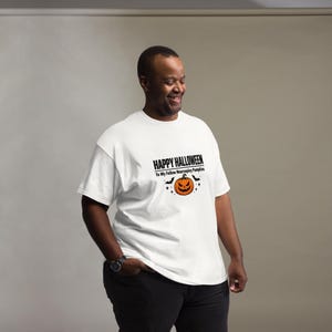 K&ouml;nnte beinhalten: Ein wei&szlig;es kurz&auml;rmeliges T-Shirt mit einem Grafikdruck auf der Brust, der den Text "HAPPY HALLOWEEN To My Fellow Neurospicy Pumpkins" &uuml;ber einer orangefarbenen K&uuml;rbis-Illustration zeigt, umgeben von kleinen schwarzen Flederm&auml;usen und Sternen.