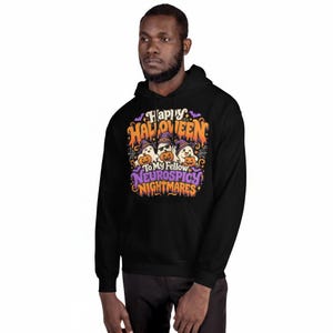 May include: A black hooded sweatshirt featuring a graphic print with three ghosts wearing purple witch hats and holding orange pumpkins. The text reads Happy Halloween To My Fellow Neurospicy Nightmares in orange, white, and purple lettering.