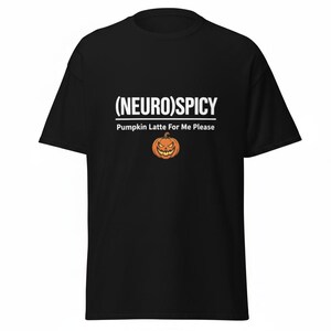 May include: A black short-sleeved t-shirt featuring the white text (NEURO)SPICY with a line underneath, followed by the text Pumpkin Latte For Me Please and a graphic of an orange jack-o'-lantern pumpkin with a jagged, smiling face.