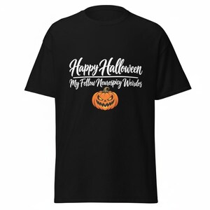 May include: A black short-sleeved t-shirt featuring white text that reads Happy Halloween My Fellow Neurospicy Weirdos. Below the text is a graphic of an orange jack-o'-lantern pumpkin with a menacing facial expression and a green stem.