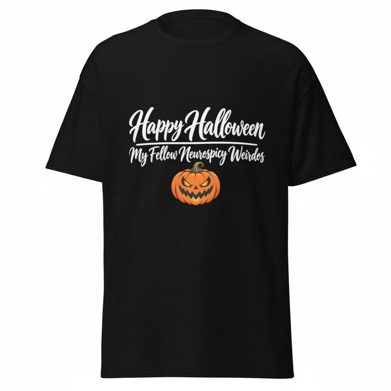 May include: A black short-sleeved t-shirt featuring white text that reads Happy Halloween My Fellow Neurospicy Weirdos. Below the text is a graphic of an orange jack-o'-lantern pumpkin with a menacing facial expression and a green stem.