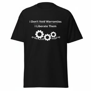 May include: A black short-sleeved t-shirt featuring white text that reads I Don't Void Warranties I Liberate Them. Below the text is a white graphic of three interlocking gears positioned above a horizontal circuit board line design.