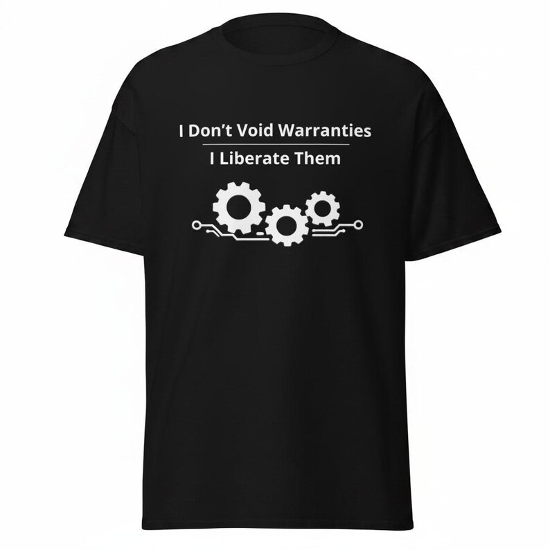 May include: A black short-sleeved t-shirt featuring white text that reads I Don't Void Warranties I Liberate Them. Below the text is a white graphic of three interlocking gears positioned above a horizontal circuit board line design.