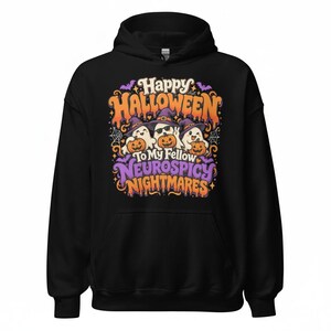 May include: A black hooded sweatshirt featuring a graphic print with three ghosts wearing purple witch hats and holding orange pumpkins. The text reads Happy Halloween To My Fellow Neurospicy Nightmares in orange and purple lettering with bats.