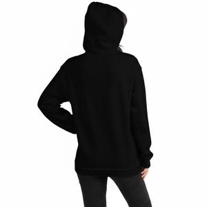 May include: A solid black long-sleeve hooded sweatshirt featuring a hood, long sleeves with ribbed cuffs, and a straight hemline. The garment is shown from the back, displaying a plain, unpatterned black fabric construction throughout the entire piece.