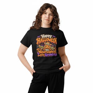May include: A black short-sleeved t-shirt featuring a colorful Halloween graphic with orange, purple, and green accents. The design includes three small creatures, pumpkins, and the text: Happy Halloween You Neurospicy Little Gremlins.
