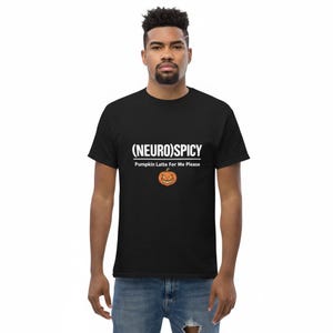 May include: A black short-sleeved t-shirt featuring the white text (NEURO)SPICY and Pumpkin Latte For Me Please, centered above a small orange jack-o'-lantern graphic with a jagged, smiling face and triangular eyes.