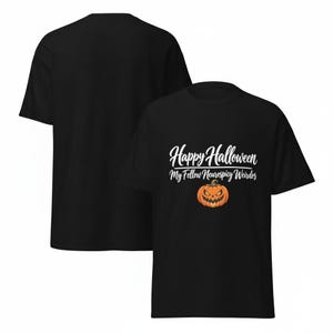 May include: A black short-sleeve t-shirt featuring the white text Happy Halloween My Fellow Neurospicy Weirdos above an orange jack-o'-lantern pumpkin graphic with a jagged, menacing grin and triangular eyes on the front of the garment.