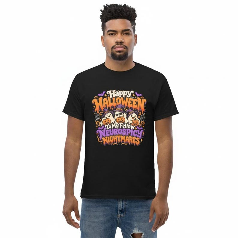 May include: A black short-sleeved t-shirt featuring a graphic with three ghosts wearing purple witch hats and sunglasses, holding orange jack-o'-lanterns. The text reads Happy Halloween To My Fellow Neurospicy Nightmares in orange and purple.