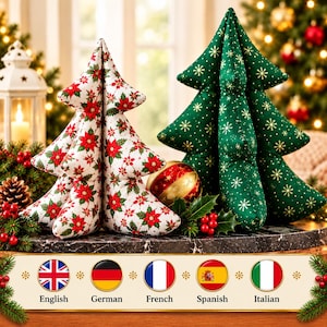 May include: Two plush fabric Christmas trees. One tree features a white background with a red and green poinsettia floral pattern. The second tree is dark green with a gold snowflake pattern. Both are soft, stuffed, and conical.