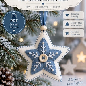 Pode incluir: Um molde de costura em PDF para um enfeite de estrela de feltro intitulado The Polar Star. O enfeite apresenta um design de estrela de feltro em camadas brancas e azuis com bordado branco, um botão de madeira central e uma fita azul.