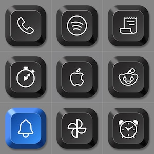 May include: A grid of nine square keyboard keys with rounded corners. Eight keys are black and one key in the bottom left is blue. Each key features a white line-art icon representing a phone, Spotify, receipt, stopwatch, Apple, Reddit, bell, photos, and alarm clock.