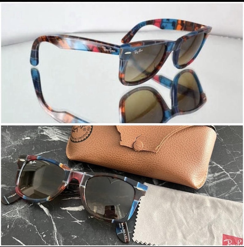 Puede incluir: Gafas de sol Ray-Ban con montura de carey multicolor en tonos azules, rojos y marrones, lentes oscuras y remaches plateados. Incluye un estuche protector de textura de cuero color canela y un pa&ntilde;o de limpieza de microfibra gris.
