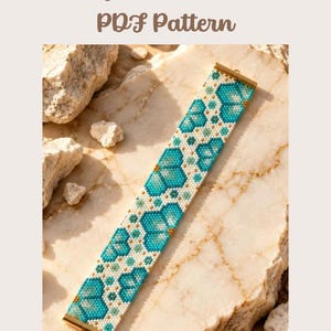 May include: A Peyote Bracelet PDF Pattern featuring a beaded bracelet with a repeating floral motif in shades of turquoise, white, and gold. The bracelet has gold-toned metal end caps at both the top and bottom edges.