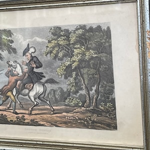 May include: A vintage black and white print of a man on horseback being robbed by two men. The print is framed in a silver frame and has the text "DOCTOR SYNTAX" and "A JOURNEY TO COVENTRY" at the bottom.