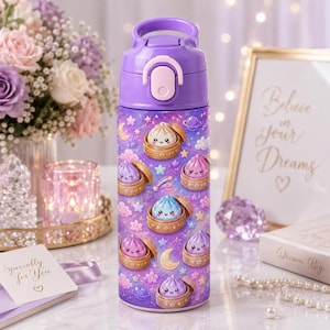 May include: A purple water bottle featuring a repeating pattern of cute, smiling dumplings in bamboo steamers, surrounded by stars, moons, and planets on a purple background. The bottle has a purple lid with a light pink latch and a carry handle.