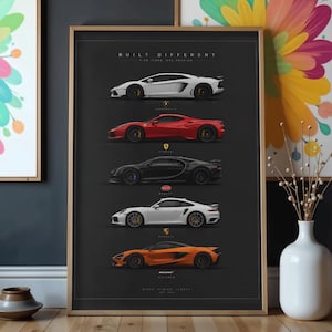 May include: A framed vertical poster on a dark gray background featuring five sports cars in profile view, arranged vertically. The text "BUILT DIFFERENT" appears at the top, with individual car brand logos and names positioned below each vehicle.
