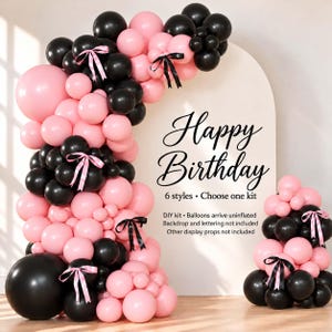 May include: A balloon garland kit featuring matte black and light pink balloons of various sizes, accented with black and pink satin ribbons. The text reads: Happy Birthday, 6 styles • Choose one kit, DIY kit • Balloons arrive uninflated.