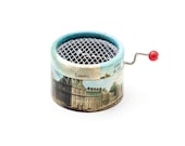 Little  music box with a hand cranked mechanism. Decorated with Paris Buildings