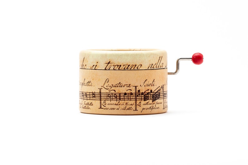 Small music box decorated with ancient musical writing. Choose your song from 60 different 