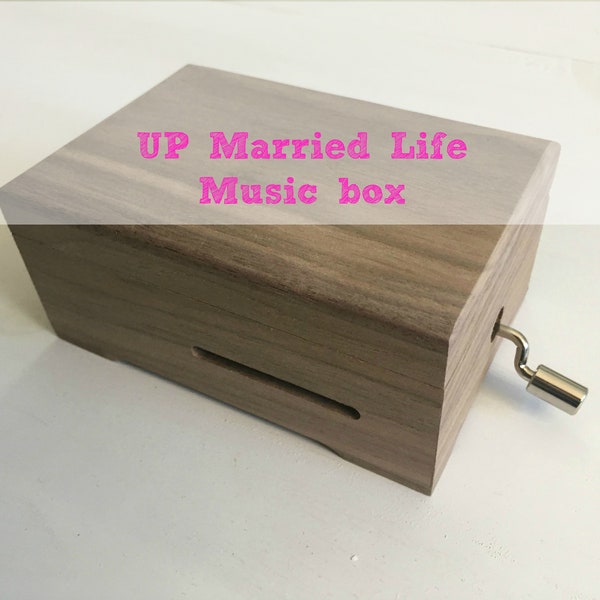 Up, married life. Wooden music box with a hand cranked musical mechanism of 15 notes. Choose a second gift melody.