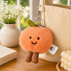 Portachiavi di peluche a forma di pesca sorridente, ciondolo per borsa con gambe in velluto a coste kawaii, giocattolo alla moda con clip per zaino