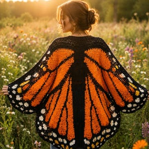 May include: A crochet cardigan featuring a monarch butterfly wing pattern in vibrant orange, black, and white. The garment has a wide, open-front design with intricate wing-like details and small white floral accents along the scalloped edges.